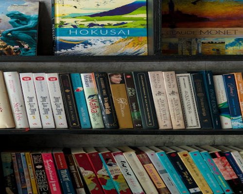 A well-organized shelf displaying classic and contemporary Peruvian literature